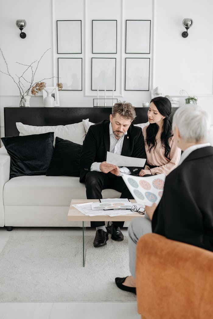why-choose-us Couple reviewing documents with a social worker at home, discussing adoption.